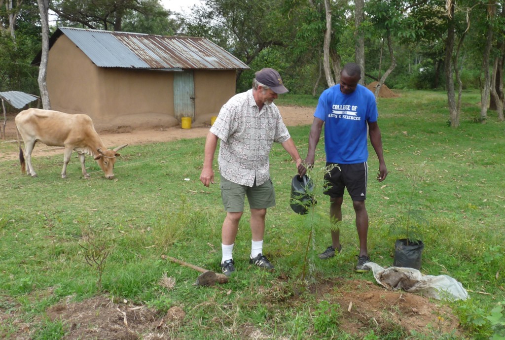Rick Peterson plants a tree with Matthew Ogutu in his compound. Ogutu’s story of transitioning from professional sand harvester 