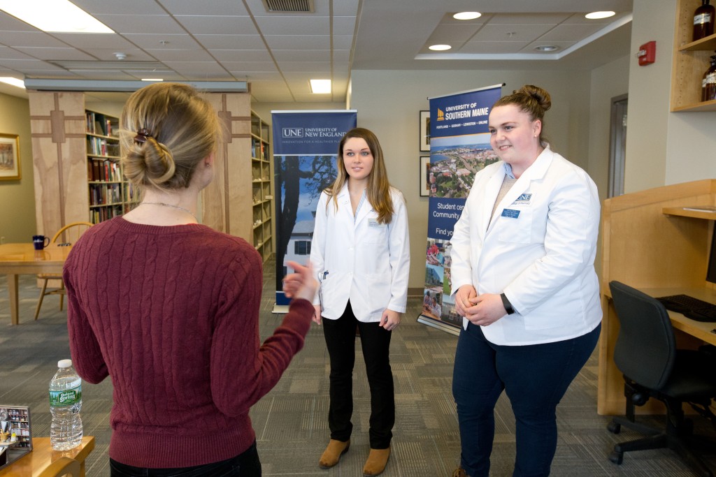 Lilia Brooks, a current USM student planning to study pharmacy at UNE, talks with Marlee Smith and Jenna Douglas