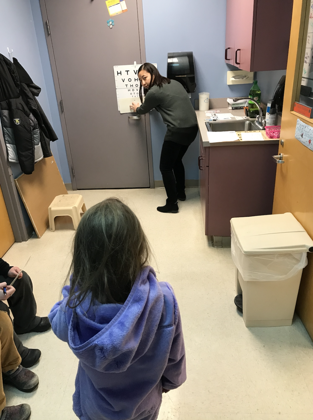Bora Park (D.O., ’22) performs a screening to test far distance vision at Biddeford Primary School.