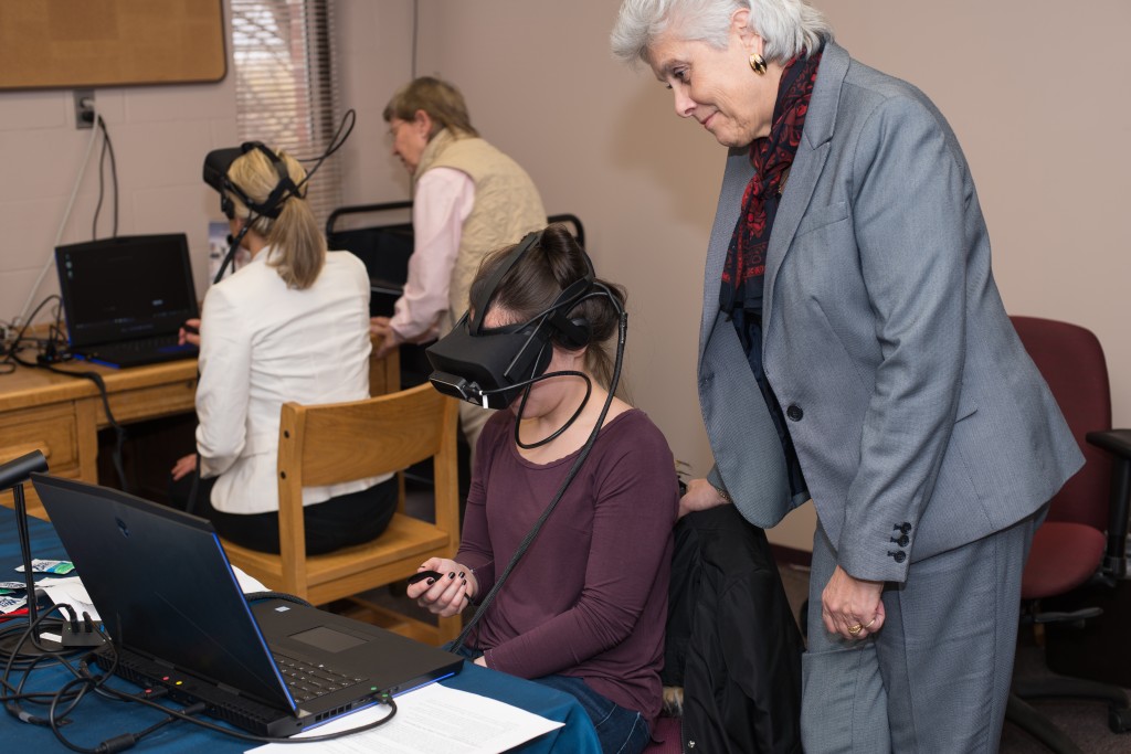 Marilyn Gugliucci oversees a student using a VR simulator