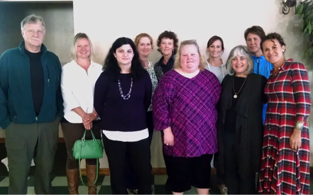 Shelley Cohen-Konrad and Arabella Perez with several graduates of the UNE School of Social Work