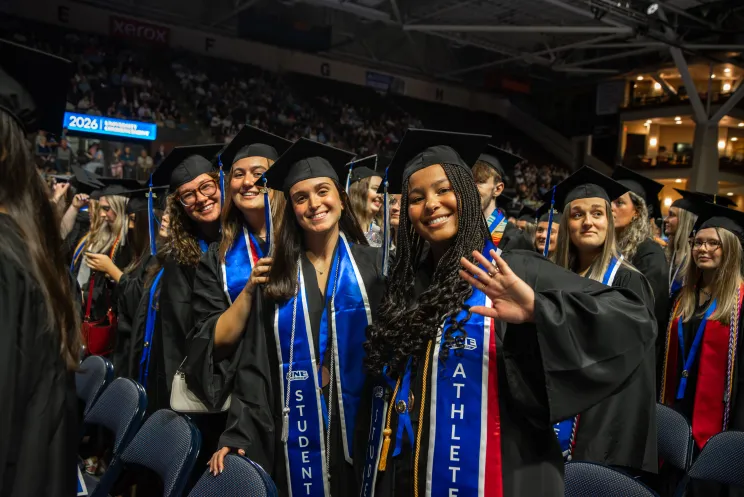 Students post for a group photo at UNE's 2026 Commencement