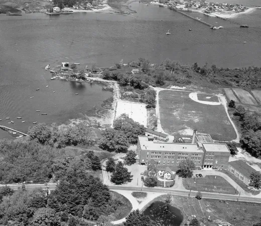 Historical black-and-white aerial photograph from 1954 showing The Wayside building on UNE's Biddeford Campus before it was razed in 1963.