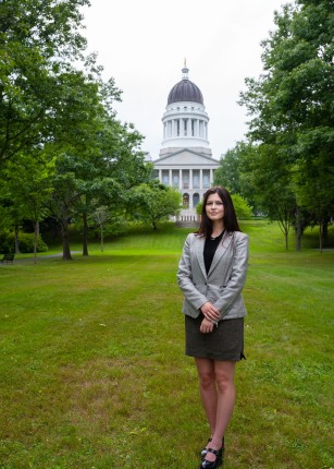Kiara Frischkorn poses in front of the Maine State House