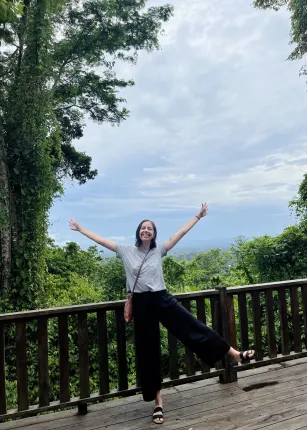 Celia Larson stands against the jungle at a resort in Belize