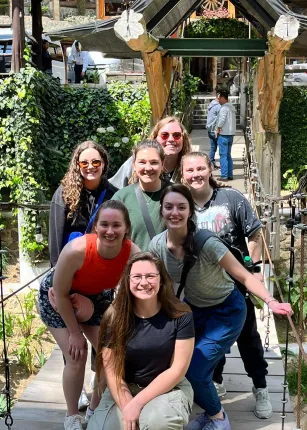 A group of students poses in front of a bridge in Guatemala