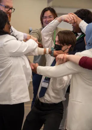 Osteopathic medical students try to unwind a "human knot" as part of a communication exercise