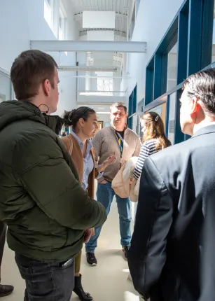 The delegates stand in the hallway of the Marine Science Center