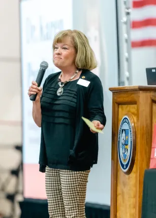 Associate Provost for Strategic Initiatives Karen Pardue stands onstage