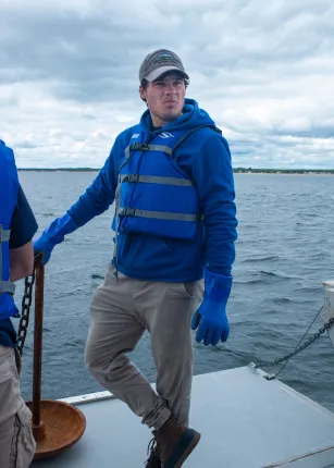 A student stands aboard the research vessel