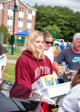 A student and her family shuffle belongings