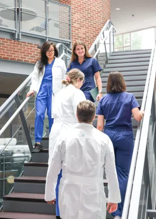 Medical students pass by each other on the stairs