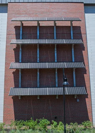 Four rows of solar cells on a side of the Commons building