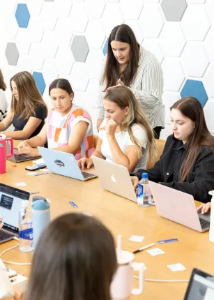 A woman leads a workshop in a UNE conference room