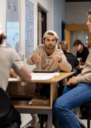 A student points to his project in the Makerspace