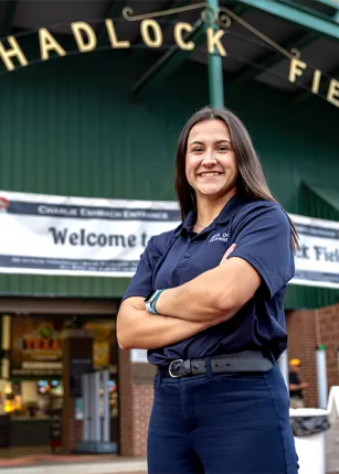  UNE student Morgan White standing in front Hadlock Field for a business internship with Seadogs