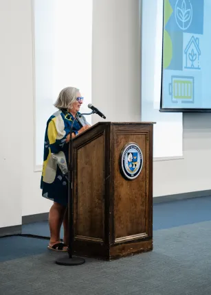UNE Provost Gwen Mahon speaks at the podium