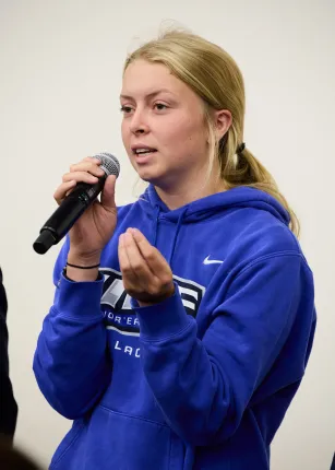 A UNE student questions the panel from the audience 