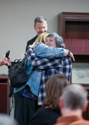 Donna Loring greets President James D. Herbert and First Lady Lynn Brandsma, Ph.D.,