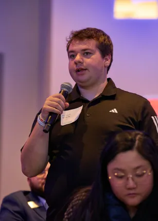 A student asks a question from the audience