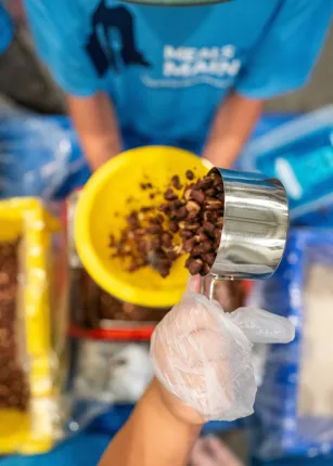 UNE, community volunteers pack a record 200,000 meal kits to combat hunger across Maine