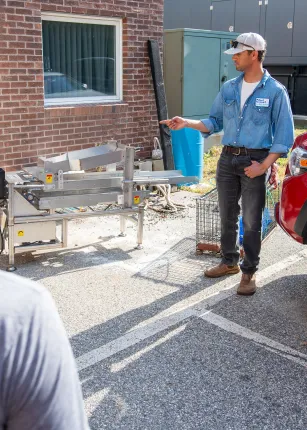 A blue economy worker showcases equipment