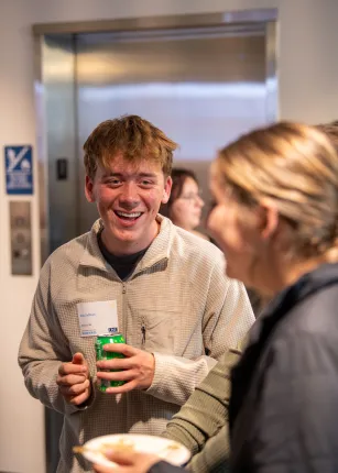 A student smiles while networking