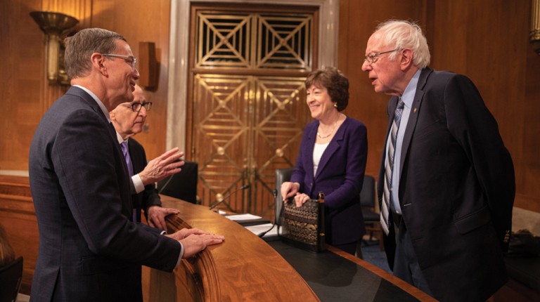 U N E president James Herbert speaks with senators Susan Collins and Bernie Sanders