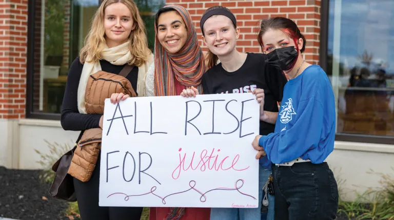 Three U N E students at the Women's March 2021