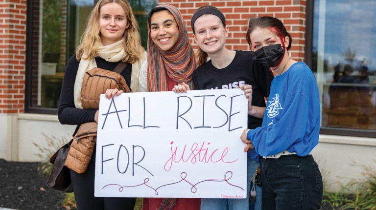 Three U N E students at the Women's March 2021