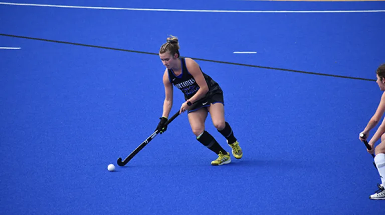 UNE women's field hockey team handles the ball