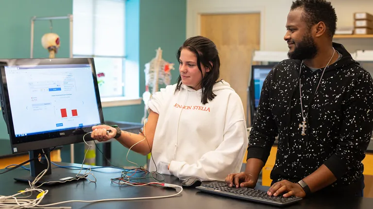Two students testing technology in the biology lab