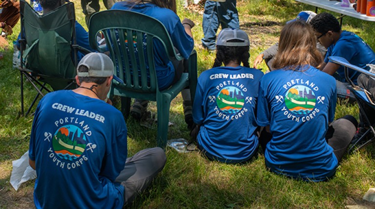 Portland Youth Corps participants sit at the site