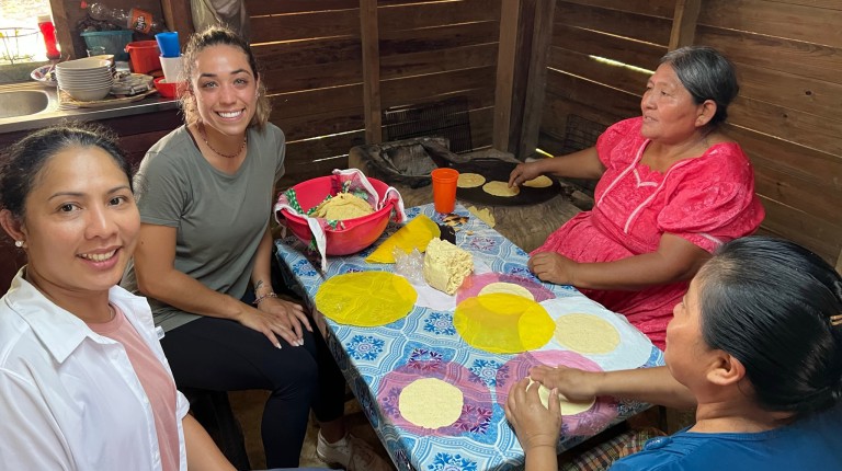 Ana Maria Castellanos makes tortillas with Kekchi Mayan women
