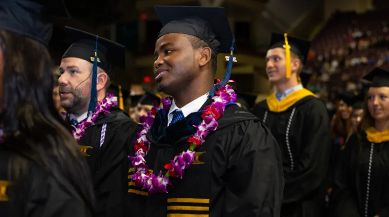 Students sit at Commencement