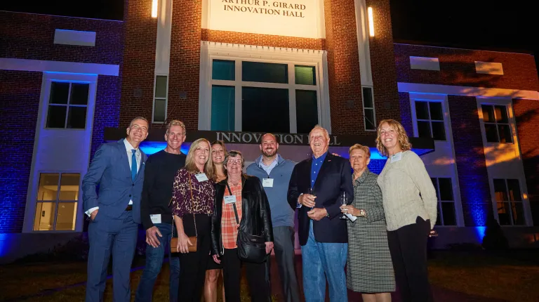 UNE administration poses with Art Girard in front of the newly dedicated Arthur P. Girard Innovation Hall