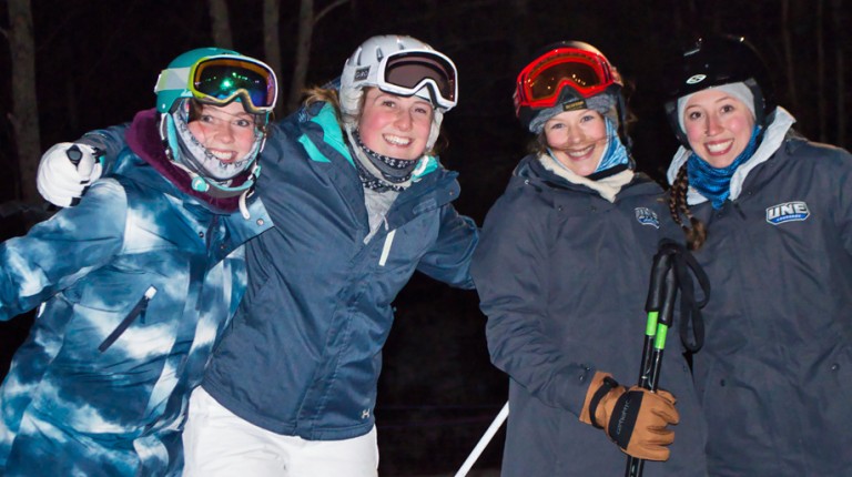 Four U N E students on a ski trip