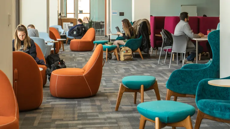 Several students studying in the Commons