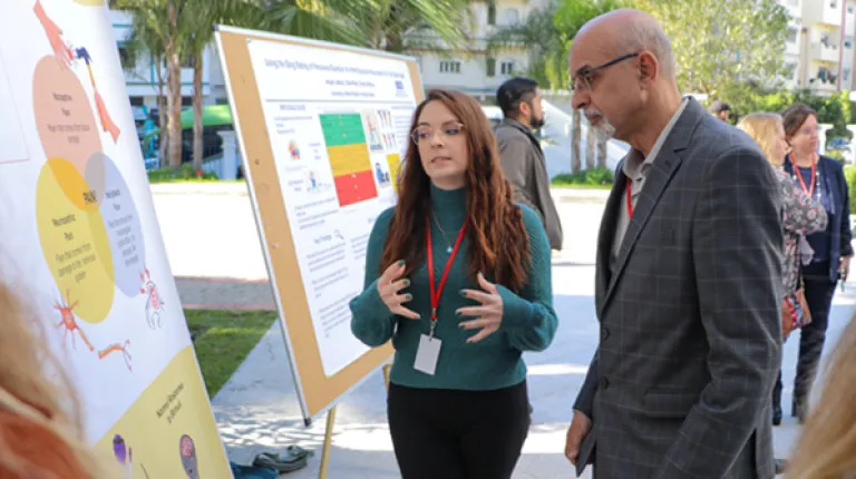Photo of O T and P T research poster session at a conference on the U N E Morocco campus