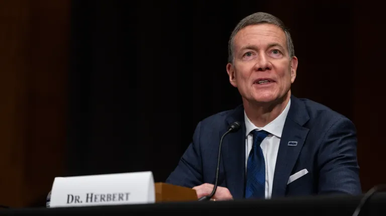 UNE President James Herbert in a Congressional chamber during testimony