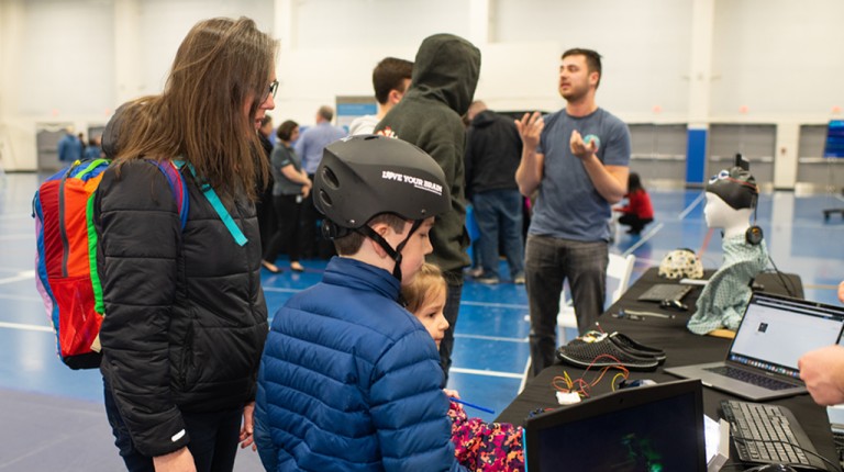 A mother and her son learning about technology during the Brain Fair