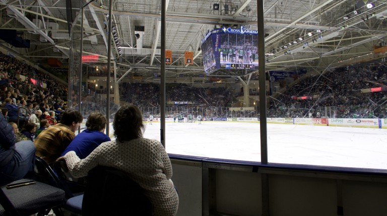 Students watch a Maine Mariners hockey game