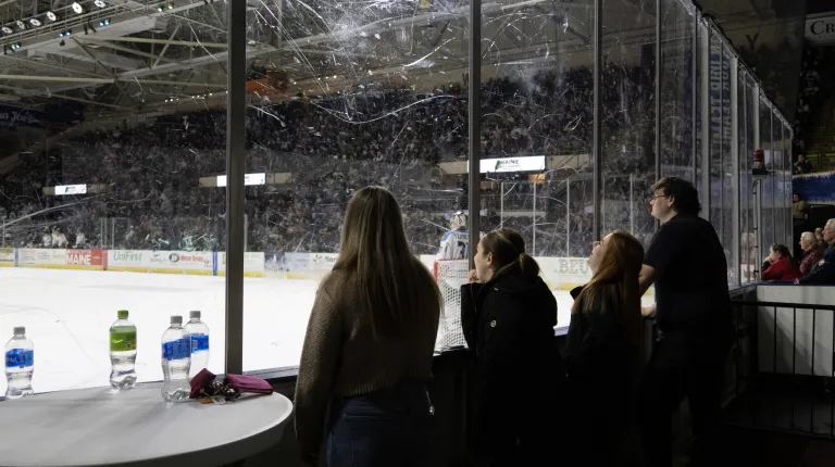 Students watch a Maine Mariners hockey game