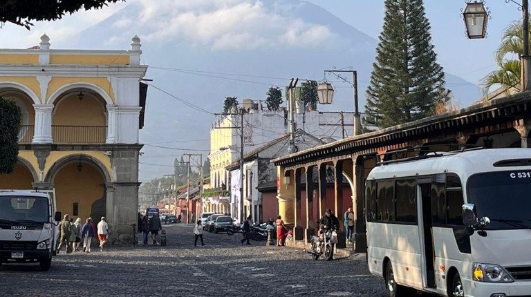 A street and mountain view from a Guatemalan city is shown