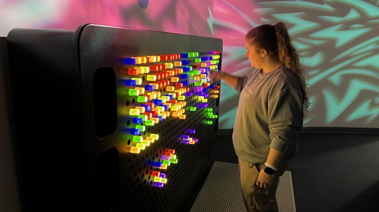 Students play with a giant Lite Brite at the museum