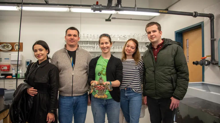 The delegates pose with UNE's famous yellow lobster Banana