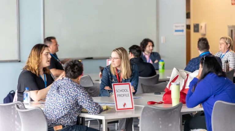 Attendees gather at a table