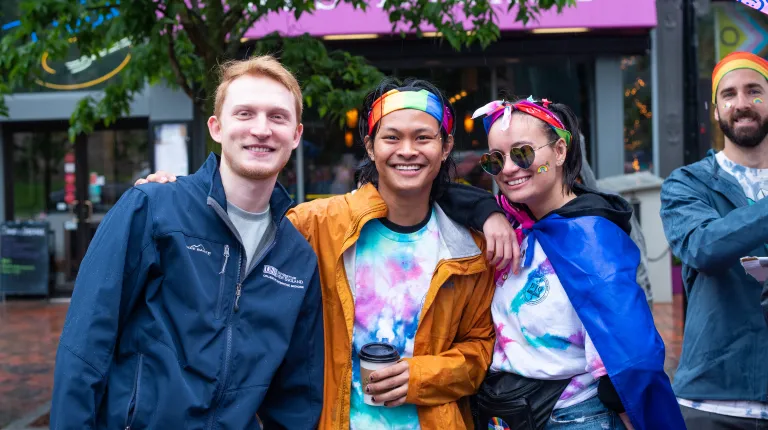 Three students pose for a photo