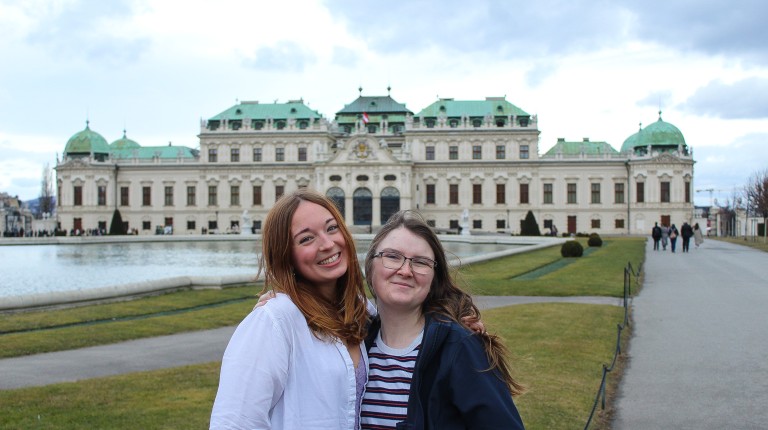Two students pose in front of the Belvedere Museum buidling in Vienna, Austria
