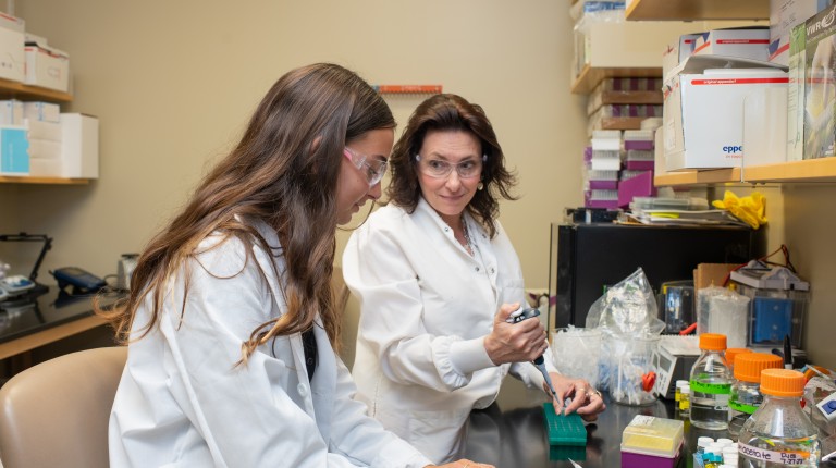 Deb Barlow works with a student in the Portland Laboratory for Biotechnology and Health Sciences